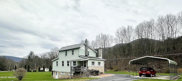 2155 Slacks Run Rd, Trout Run, PA 17771 - view of home's exterior featuring a lawn, a carport, driveway, and a chimney