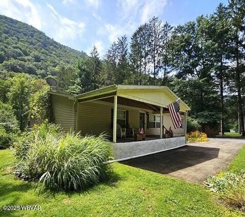 68 Sassafras Ln, Waterville, PA 17776 - back of house featuring a porch, a yard, and a mountain view