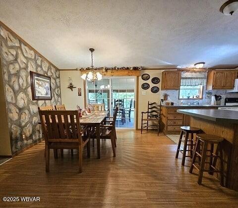 68 Sassafras Ln, Waterville, PA 17776 - dining area with ornamental molding, a textured ceiling, a chandelier, and dark wood-style floors