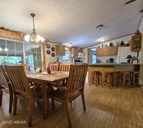 68 Sassafras Ln, Waterville, PA 17776 - dining space with a textured ceiling, lofted ceiling, wood finished floors, and a chandelier
