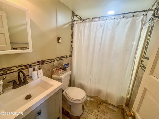 bathroom featuring tile patterned floors, vanity, toilet, and backsplash