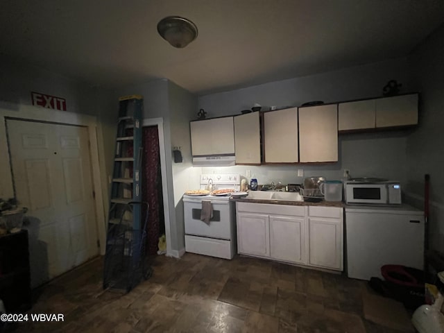 kitchen with white appliances, extractor fan, and sink