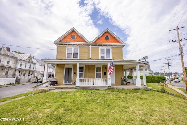 view of front facade with covered porch and a front yard