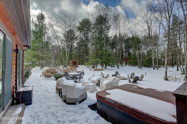 yard covered in snow with a hot tub