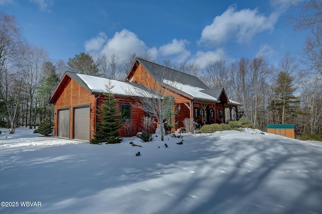 view of snowy exterior with a garage