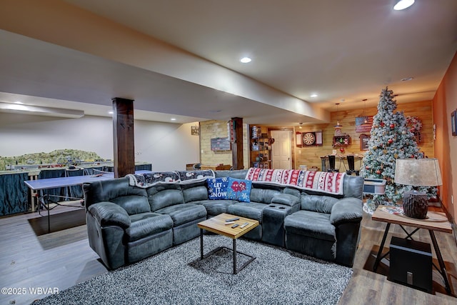 living room featuring hardwood / wood-style flooring and wood walls