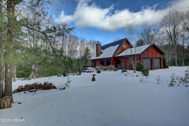 snow covered property featuring a garage