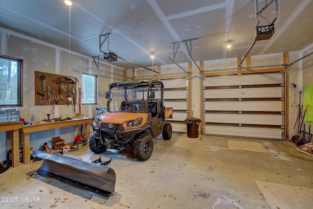 garage with a garage door opener and a workshop area