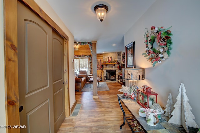 corridor with light hardwood / wood-style floors