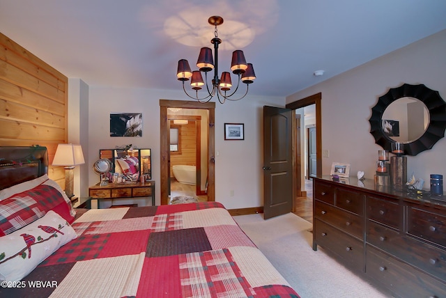 bedroom with light carpet, connected bathroom, and an inviting chandelier