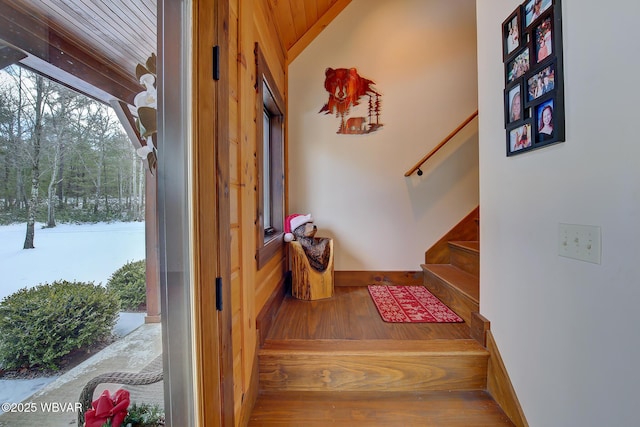 staircase featuring lofted ceiling and hardwood / wood-style flooring