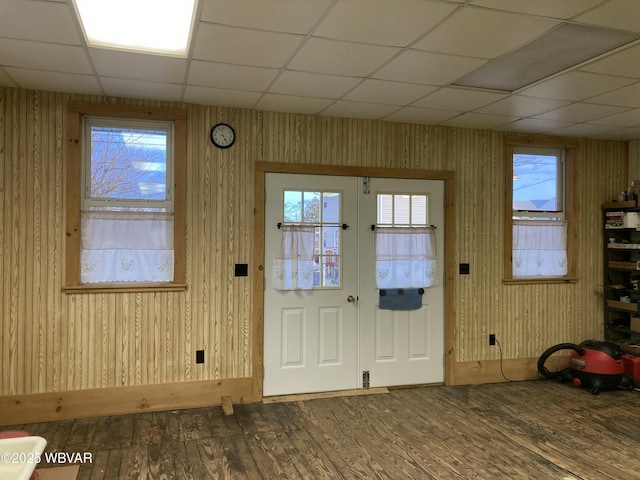 doorway to outside featuring french doors, dark hardwood / wood-style floors, and wood walls