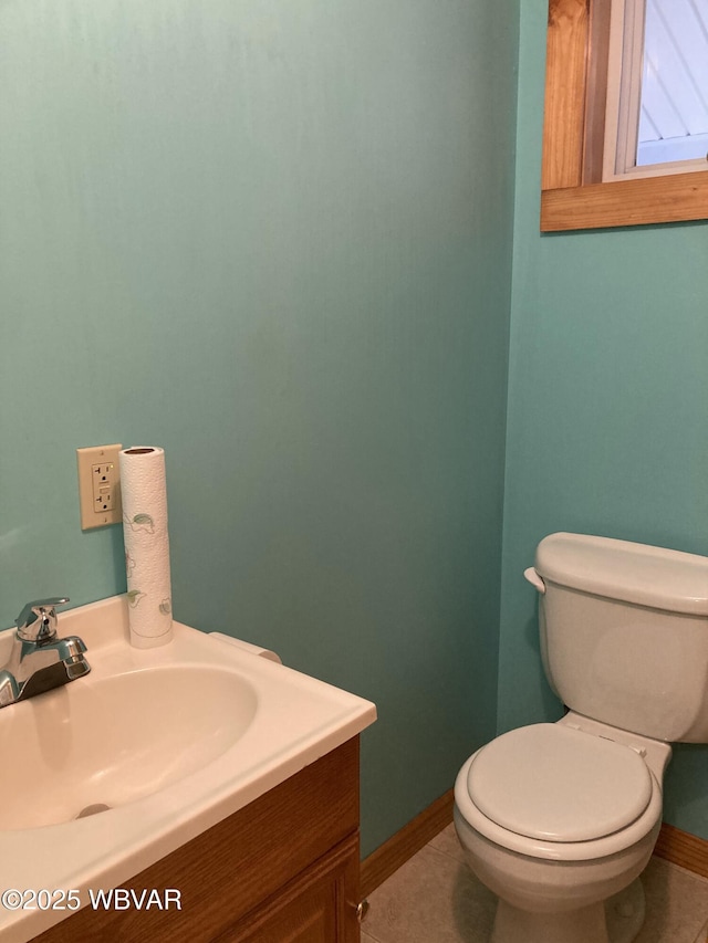 bathroom with tile patterned flooring, vanity, and toilet