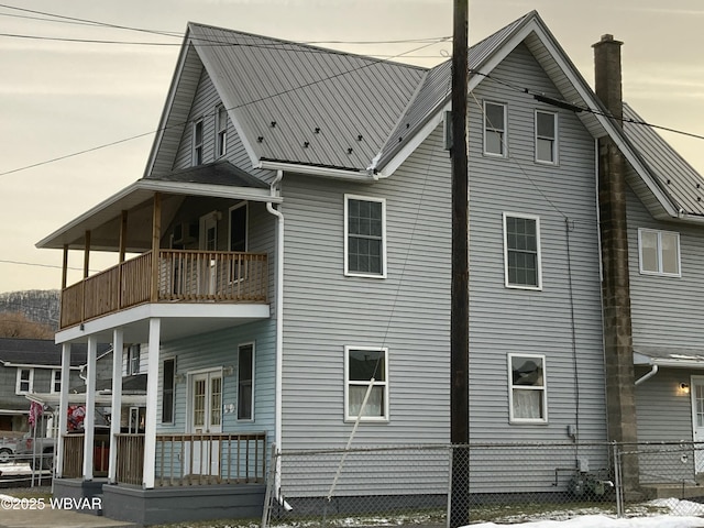 property exterior at dusk with a balcony