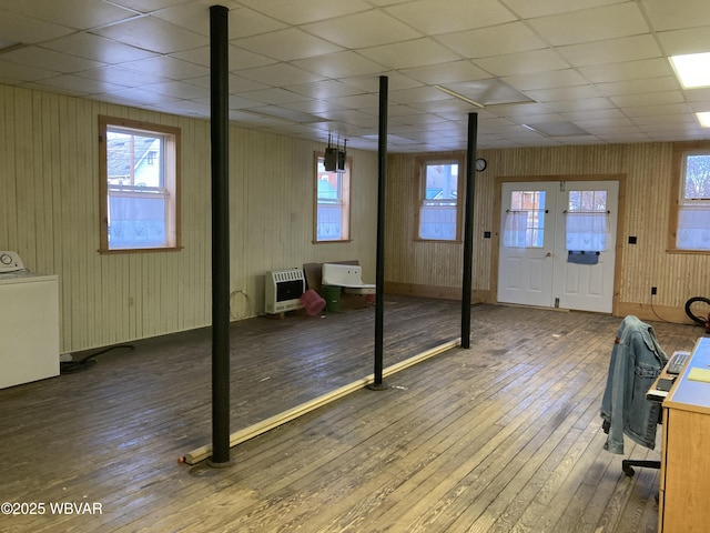 interior space featuring washer / clothes dryer, hardwood / wood-style floors, heating unit, and a paneled ceiling