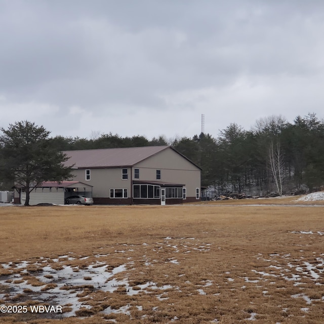 rear view of house with a sunroom