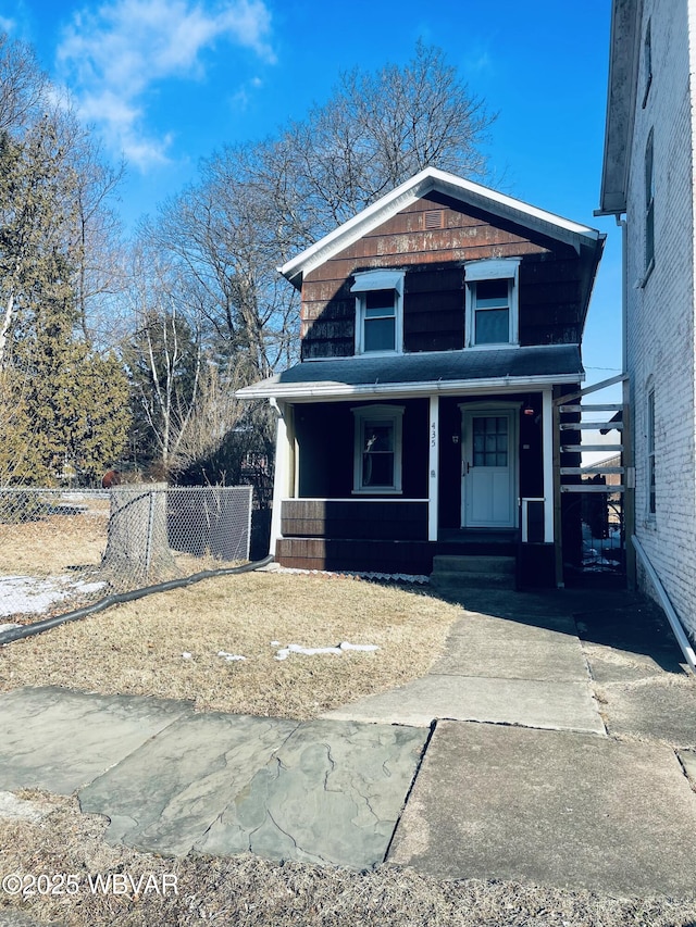 view of front of house with a porch and fence