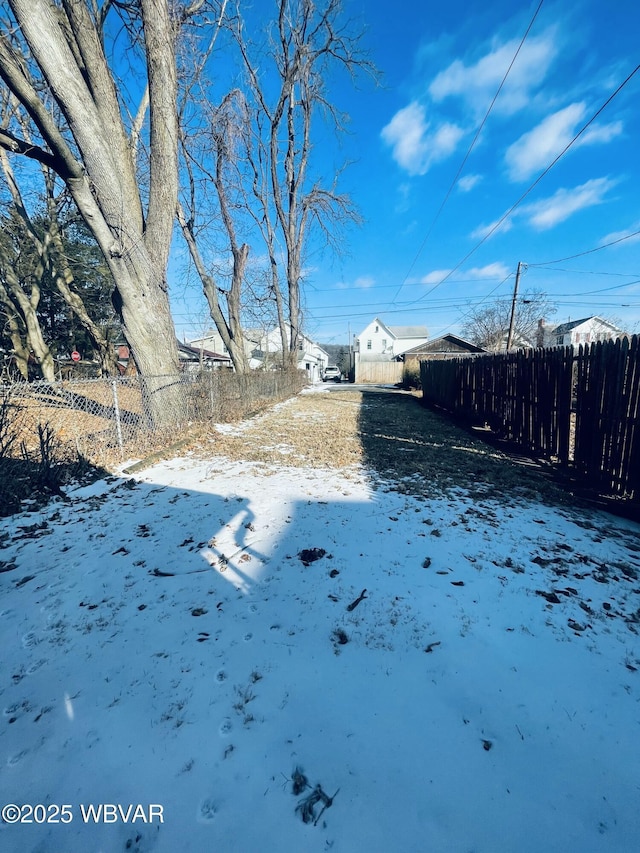 yard covered in snow with fence