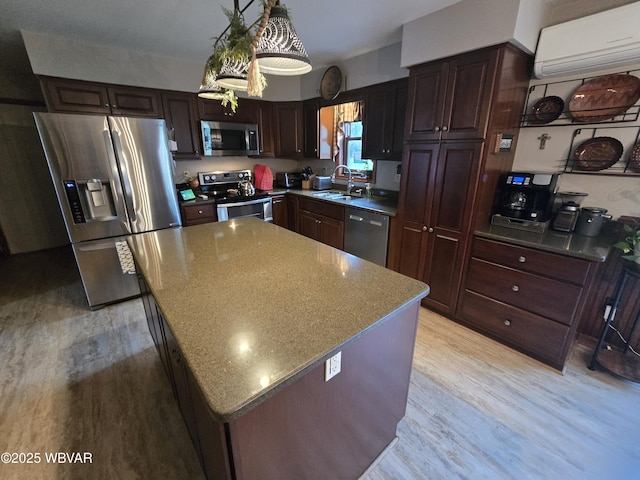 131 Walnut Ln, Jersey Shore, PA 17740 - kitchen with stainless steel appliances, a wall mounted AC, light wood finished floors, a kitchen island, and dark brown cabinets