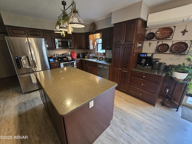 131 Walnut Ln, Jersey Shore, PA 17740 - kitchen with appliances with stainless steel finishes, a wall mounted air conditioner, light wood-type flooring, dark brown cabinets, and a center island