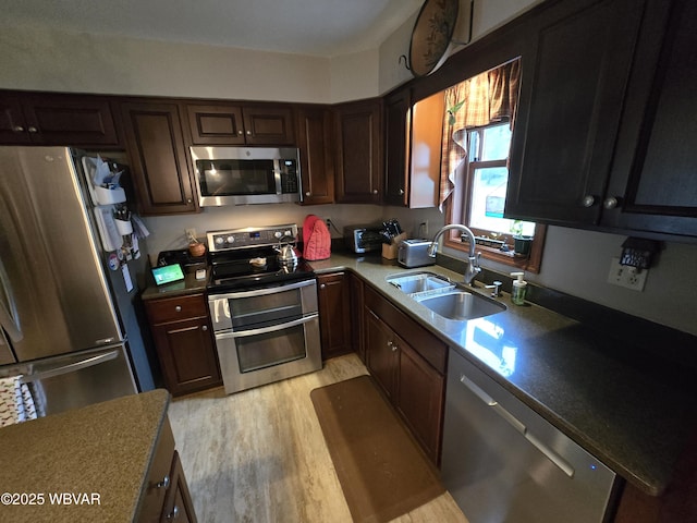 131 Walnut Ln, Jersey Shore, PA 17740 - kitchen featuring appliances with stainless steel finishes, light wood finished floors, and dark brown cabinets