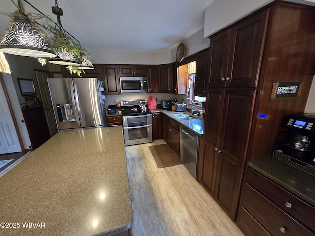 131 Walnut Ln, Jersey Shore, PA 17740 - kitchen featuring stainless steel appliances, dark brown cabinetry, and pendant lighting