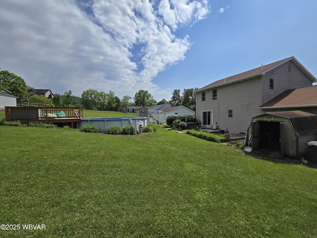 131 Walnut Ln, Jersey Shore, PA 17740 - view of grassy yard with a storage shed, a deck, and an outdoor pool