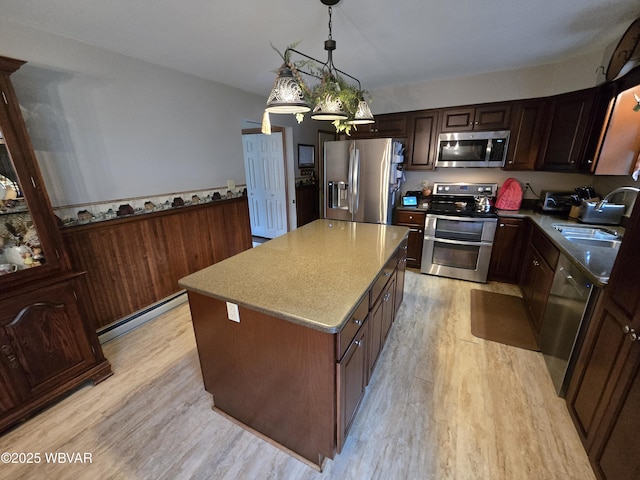 131 Walnut Ln, Jersey Shore, PA 17740 - kitchen featuring stainless steel appliances, baseboard heating, light wood-style floors, and decorative light fixtures