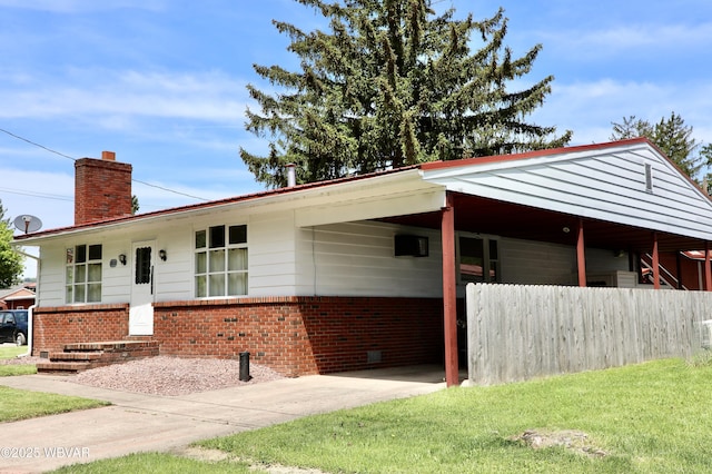 3630 Linn St, Cogan Station, PA 17728 - ranch-style home with brick siding, a chimney, an attached carport, and concrete driveway
