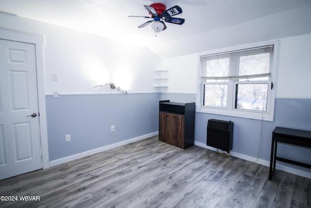 interior space featuring heating unit, ceiling fan, vaulted ceiling, and hardwood / wood-style flooring