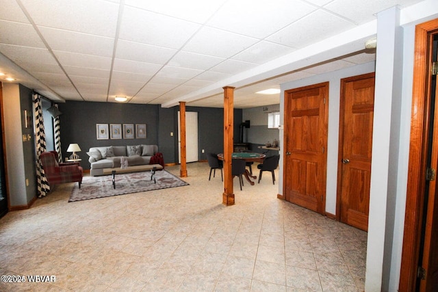 living room featuring a paneled ceiling