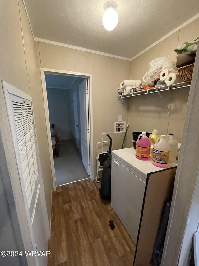 laundry room with a textured ceiling, crown molding, and dark hardwood / wood-style floors