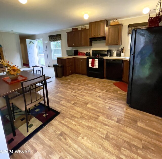 kitchen featuring black appliances and light hardwood / wood-style floors