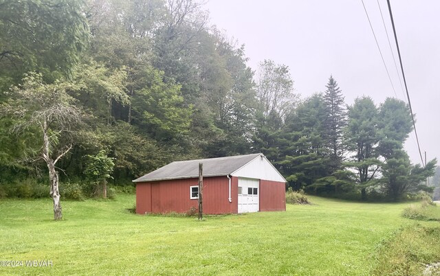 view of outdoor structure featuring a lawn