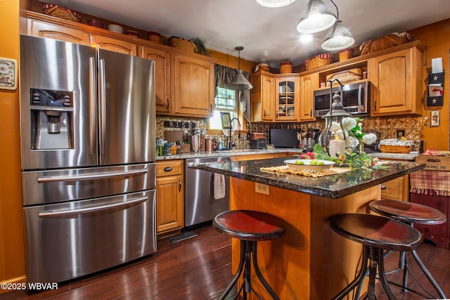 196 Shawnee Dr, Muncy, PA 17756 - kitchen with appliances with stainless steel finishes, dark wood-style floors, a breakfast bar area, and tasteful backsplash