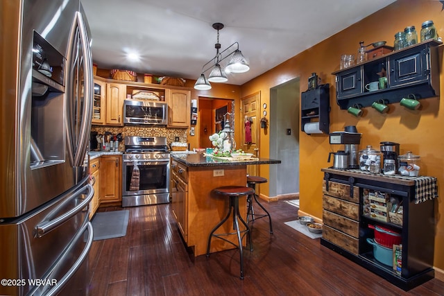 196 Shawnee Dr, Muncy, PA 17756 - kitchen featuring appliances with stainless steel finishes, a center island, a breakfast bar area, and dark wood-style floors