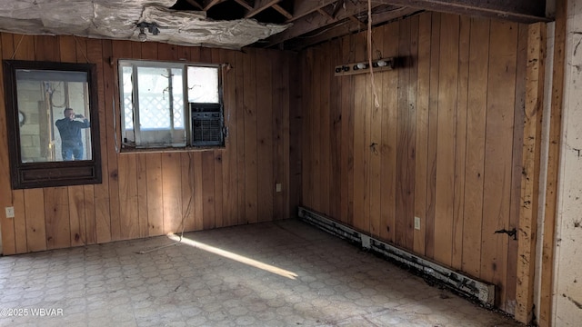 empty room with tile patterned floors and wooden walls