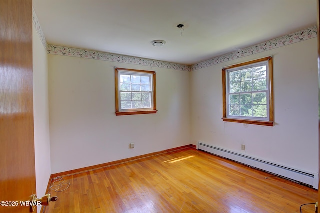 443 Derr Hill Rd, Lock Haven, PA 17745 - unfurnished room with a baseboard heating unit, light wood-style floors, and baseboards