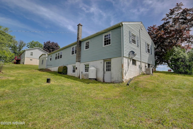 443 Derr Hill Rd, Lock Haven, PA 17745 - back of property with cooling unit, a yard, a chimney, and oil tank