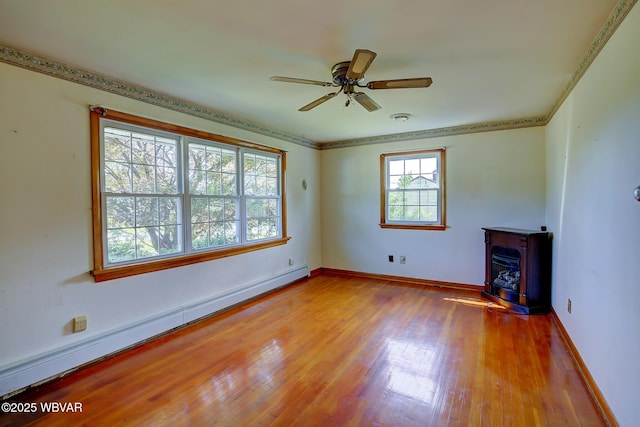 443 Derr Hill Rd, Lock Haven, PA 17745 - unfurnished living room with a baseboard heating unit, a wood stove, wood finished floors, ceiling fan, and baseboards
