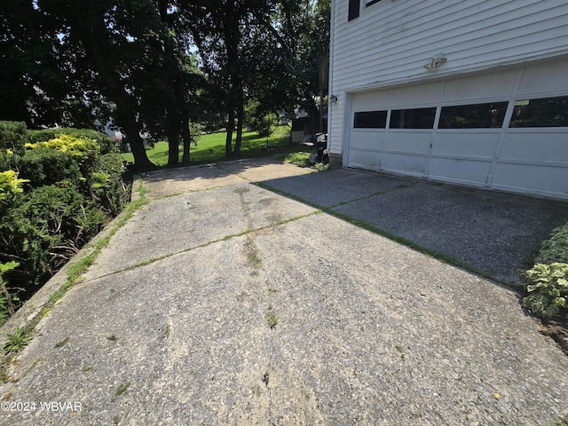 view of patio featuring a garage and driveway