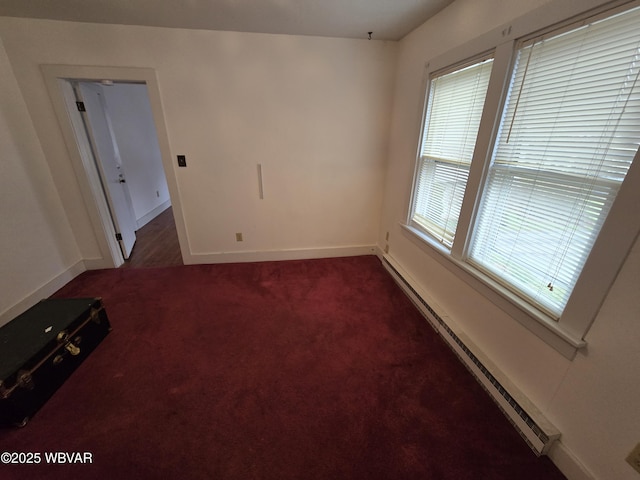 spare room with baseboards, carpet flooring, and baseboard heating