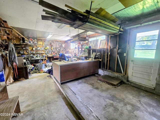 misc room with concrete flooring and a workshop area