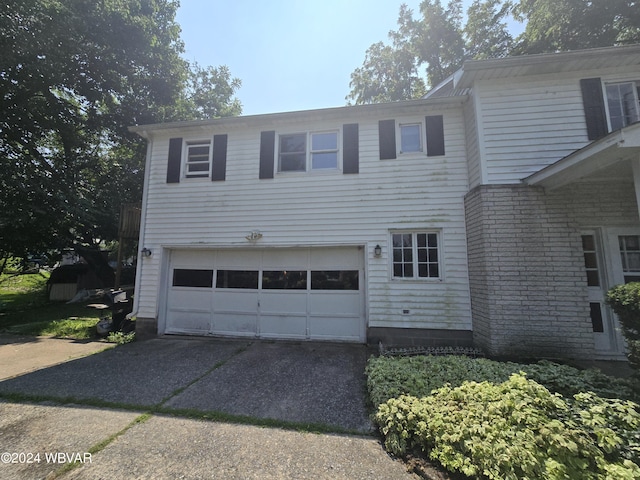 view of front of home featuring concrete driveway and an attached garage