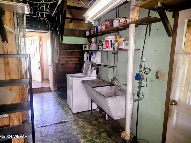 laundry area with washer / clothes dryer and a sink