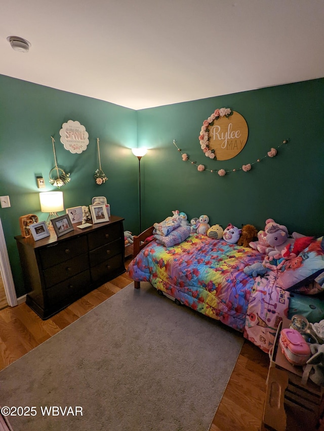 bedroom featuring wood finished floors