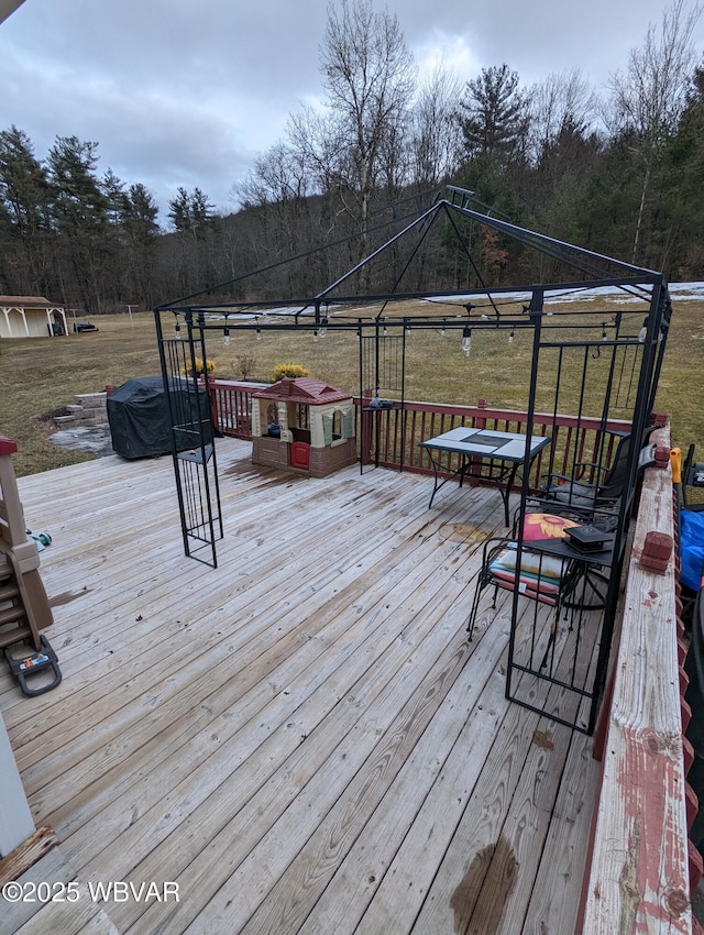 wooden terrace featuring a gazebo