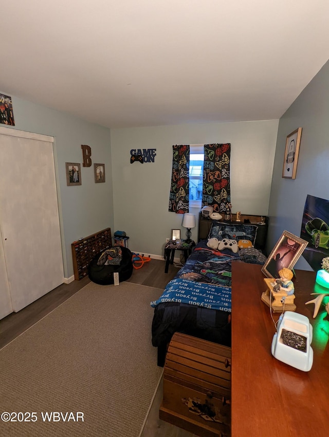 bedroom with wood finished floors and baseboards