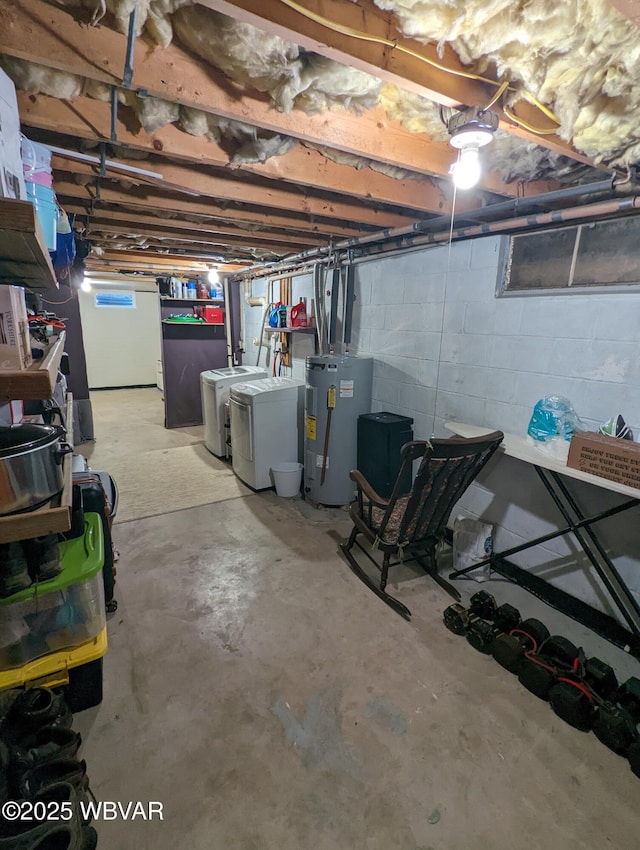 unfinished basement featuring water heater and washer and clothes dryer