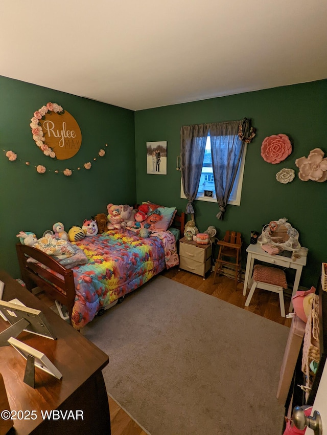 bedroom with wood finished floors